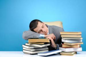 Photo of a Man Sleeping on Books