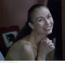 Woman smiling with hands folded